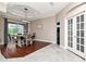 Elegant dining room featuring modern lighting, stylish flooring, and sliding glass doors to the lanai at 12309 Creek Edge Dr, Riverview, FL 33579