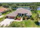 Waterfront home boasts lush landscaping, a two-car garage, and a meticulously maintained lawn at 12309 Creek Edge Dr, Riverview, FL 33579