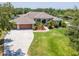 Beautiful home boasts a three-car garage, lush landscaping, and a circular driveway, offering curb appeal at 12309 Creek Edge Dr, Riverview, FL 33579