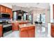 Open kitchen with an island, stainless appliances, wooden cabinets, eat in kitchen and views of the living space at 12309 Creek Edge Dr, Riverview, FL 33579