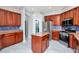 Spacious kitchen features custom wood cabinetry, stainless steel appliances, and granite countertops at 12309 Creek Edge Dr, Riverview, FL 33579