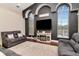 Cozy living room with plush seating, arched windows, a modern fireplace, and stylish decor at 12309 Creek Edge Dr, Riverview, FL 33579