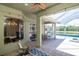 Covered patio features dining and seating areas with views of the pool and backyard at 12309 Creek Edge Dr, Riverview, FL 33579