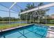 A screened in pool and hot tub is the perfect place to cool off and enjoy the beautiful backyard scenery at 12309 Creek Edge Dr, Riverview, FL 33579