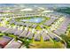 Picturesque aerial view of a community with homes surrounding a central pond at 13327 Waterleaf Garden Cir, Riverview, FL 33579
