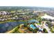 Picturesque aerial shot of a residential area with a pond, walking trails, lush greenery, and beautiful homes at 13327 Waterleaf Garden Cir, Riverview, FL 33579