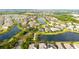 Community aerial showing a tranquil neighborhood with lush green spaces, a pond, and well-manicured lawns at 13327 Waterleaf Garden Cir, Riverview, FL 33579