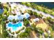 Aerial shot of community center with large swimming pool, playground, and lush landscaping, perfect for recreation and relaxation at 13327 Waterleaf Garden Cir, Riverview, FL 33579