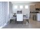 Open dining room with large window, six chairs, a table and view of the kitchen at 13327 Waterleaf Garden Cir, Riverview, FL 33579