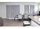 Open dining room featuring a table with six chairs and large patterned curtains for natural light at 13327 Waterleaf Garden Cir, Riverview, FL 33579
