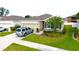 Inviting single-story home with a manicured lawn and a convenient two-car garage at 13327 Waterleaf Garden Cir, Riverview, FL 33579