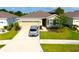 Charming single-story home with a well-maintained lawn and a two-car garage at 13327 Waterleaf Garden Cir, Riverview, FL 33579