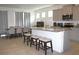Open kitchen flows into dining area with granite island seating and stainless appliances at 13327 Waterleaf Garden Cir, Riverview, FL 33579