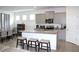 Spacious kitchen flows into living area with granite island and stainless appliances at 13327 Waterleaf Garden Cir, Riverview, FL 33579