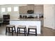 Bright kitchen boasts an island with seating, granite countertops, and stainless appliances at 13327 Waterleaf Garden Cir, Riverview, FL 33579