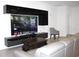 Modern living room features sleek entertainment center and comfortable seating area at 13327 Waterleaf Garden Cir, Riverview, FL 33579