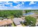 Aerial view of home with a pond in the backyard, surrounded by mature trees and landscaping at 13523 Prestwick Dr, Riverview, FL 33579