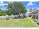 Expansive backyard with white picket fence and mature trees, providing privacy and shade at 13523 Prestwick Dr, Riverview, FL 33579