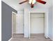 Empty bedroom boasting wood floors, an open closet, and two separate doors at 13523 Prestwick Dr, Riverview, FL 33579