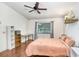 Bright bedroom with laminate floors, a cozy bed, and a large window at 13523 Prestwick Dr, Riverview, FL 33579