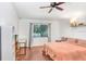 Bright bedroom with laminate floors, a cozy bed, and a large window at 13523 Prestwick Dr, Riverview, FL 33579
