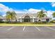 Inviting community center featuring manicured landscaping and ample parking for residents at 13523 Prestwick Dr, Riverview, FL 33579