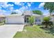 Well-kept single-story home with a two-car garage and simple, welcoming landscaping at 13523 Prestwick Dr, Riverview, FL 33579