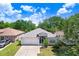 Inviting single-story home with manicured lawn, two-car garage, and bright, sunny curb appeal at 13523 Prestwick Dr, Riverview, FL 33579