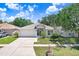 Charming single-story home with a well-maintained lawn and a two-car garage at 13523 Prestwick Dr, Riverview, FL 33579