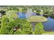 Panoramic aerial view showcasing a golf course with a pond and manicured greens at 13523 Prestwick Dr, Riverview, FL 33579