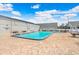 Large community swimming pool with a brick deck, lounge chairs, and shaded picnic tables at 13523 Prestwick Dr, Riverview, FL 33579