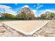 Community sand volleyball court with an open-air shelter, with blue skies and fluffy white clouds overhead at 13523 Prestwick Dr, Riverview, FL 33579