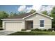 Charming single-story home featuring a two-car garage and manicured front lawn at 13556 Tropical Breeze Way, Hudson, FL 34669