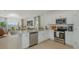 Modern kitchen with stainless steel appliances, island, and open concept layout at 13556 Tropical Breeze Way, Hudson, FL 34669