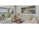 Relaxing living room with sliding doors to the patio and backyard view at 13556 Tropical Breeze Way, Hudson, FL 34669