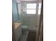 Bright bathroom featuring a tiled shower with glass door, updated sink, and tiled floors at 138 36Th N Ave # 206W, St Petersburg, FL 33704