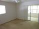 Bright bedroom featuring neutral walls, carpeted floor, a ceiling fan, and sliding glass doors at 138 36Th N Ave # 206W, St Petersburg, FL 33704