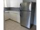 Kitchen featuring stainless steel refrigerator, white cabinets, and tiled floor at 138 36Th N Ave # 206W, St Petersburg, FL 33704