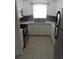 Modern kitchen with stainless steel refrigerator, white cabinets, and tiled floor at 138 36Th N Ave # 206W, St Petersburg, FL 33704