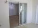 View from the lanai into the adjacent room showing a ceiling fan and closet with folding doors at 138 36Th N Ave # 206W, St Petersburg, FL 33704
