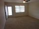 Bright living room with neutral carpet, ceiling fan, and natural light at 138 36Th N Ave # 206W, St Petersburg, FL 33704