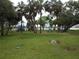 Scenic view of a neighborhood park with a playground, green lawn, and palm trees at 138 36Th N Ave # 206W, St Petersburg, FL 33704