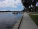 Waterfront view with a sidewalk, boats docked on the water, and palm trees along the street at 138 36Th N Ave # 206W, St Petersburg, FL 33704