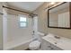 A full bathroom features a tub with shower, white vanity, and neutral wall color at 1472 Belcher S Rd, Largo, FL 33771