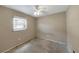 Empty room with single window featuring a ceiling fan, walls painted in neutral color at 1472 Belcher S Rd, Largo, FL 33771