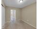 A simple bedroom with neutral walls and ceiling fixture at 1472 Belcher S Rd, Largo, FL 33771