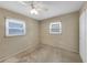Empty room with dual windows featuring a ceiling fan, walls painted in neutral color at 1472 Belcher S Rd, Largo, FL 33771