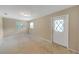 A bedroom with neutral walls, windows, and an exterior door at 1472 Belcher S Rd, Largo, FL 33771