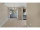 Dining area with tile flooring, chandelier, adjacent kitchen, and sliding glass doors to lanai at 1472 Belcher S Rd, Largo, FL 33771