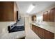 Modern kitchen featuring stainless steel appliances, granite countertops, tile floor, and wood cabinets at 1472 Belcher S Rd, Largo, FL 33771